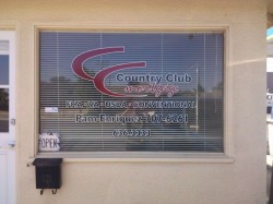 Red & black lettering with white outline on window with blinds