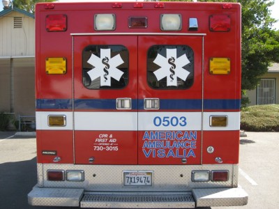 White logos on back windows of ambulance